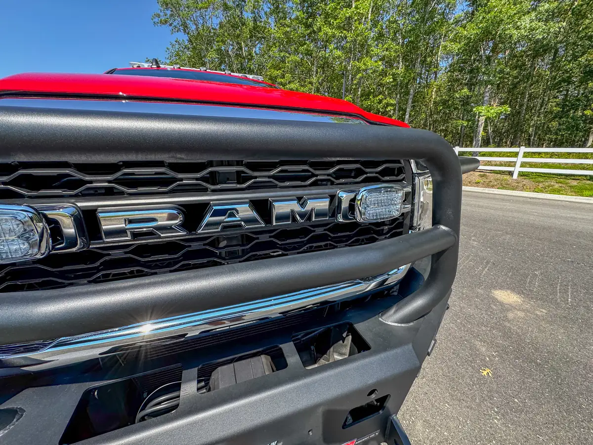 Cab roof and windshield upper view with roof rail and lightbar area.